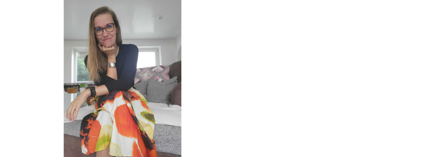 Jenni Metallidis seated in a bright room, wearing a floral skirt