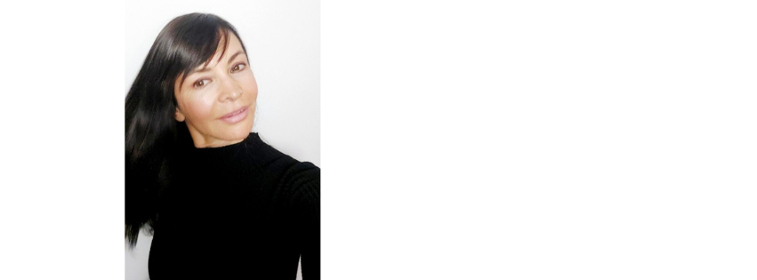 Jasmina Panich with dark hair, photographed against a pale background
