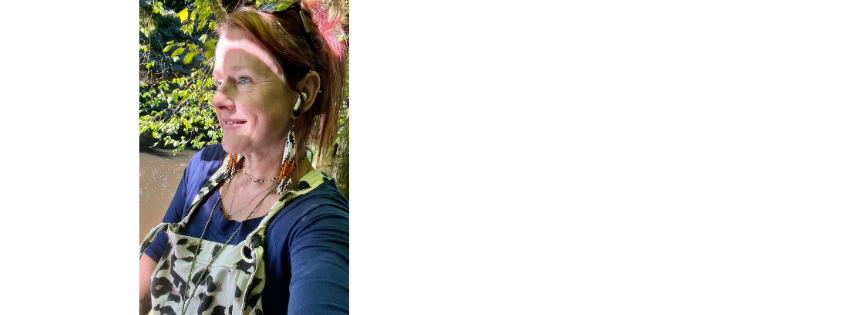 Lix Kendal outdoors, wearing long earrings and smiling