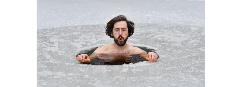 A man submerged to his chest in a hole cut through ice