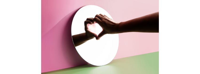 Two hands forming a heart shape with light passing through