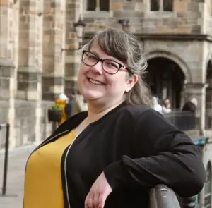 Laura Dumbleton smiling outside a stone building